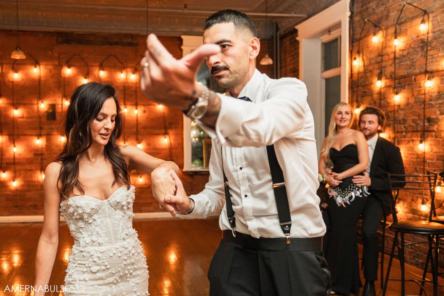 A couple shares an emotional dance moment at their wedding reception.