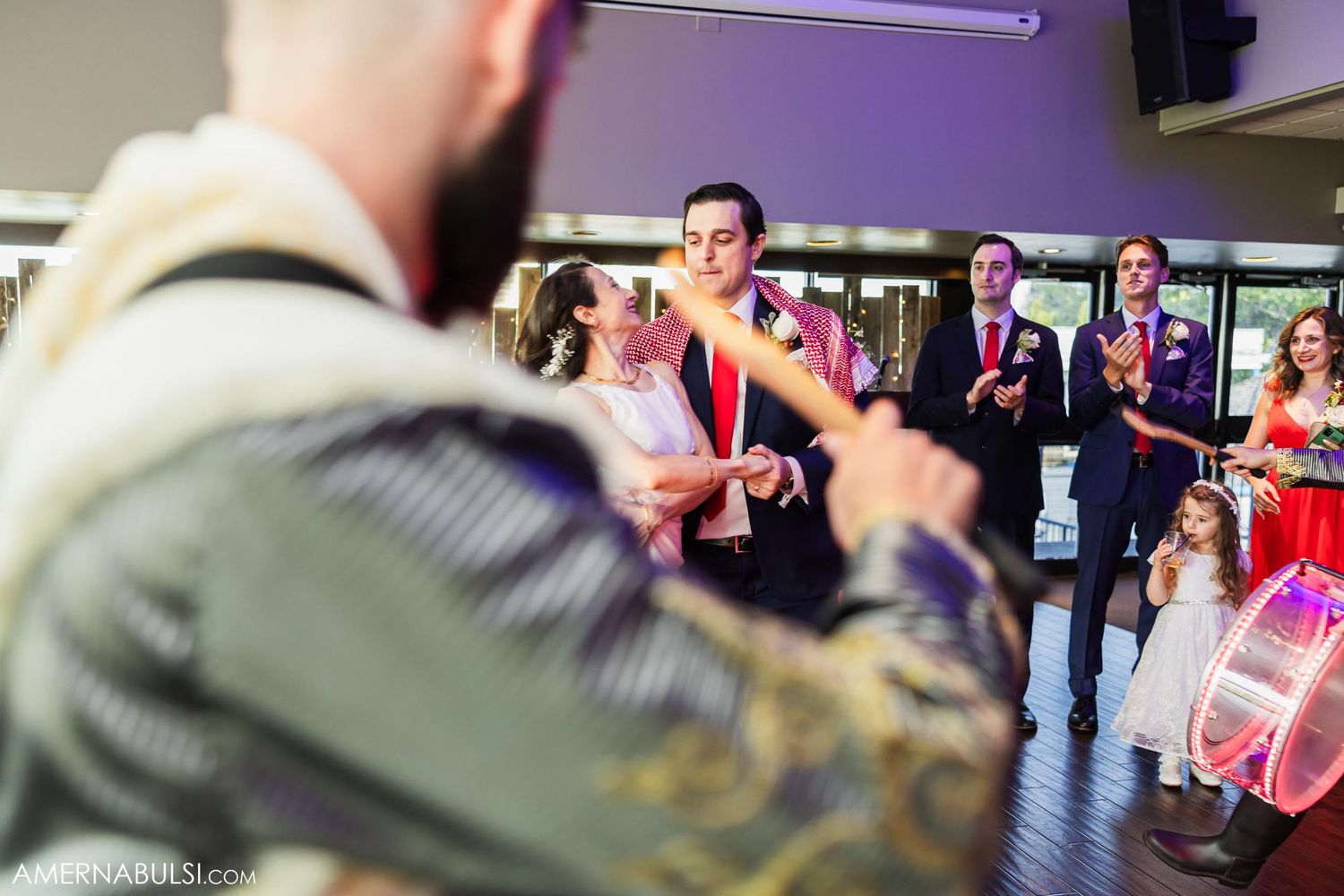 Musicians play drums during energetic wedding reception performance.