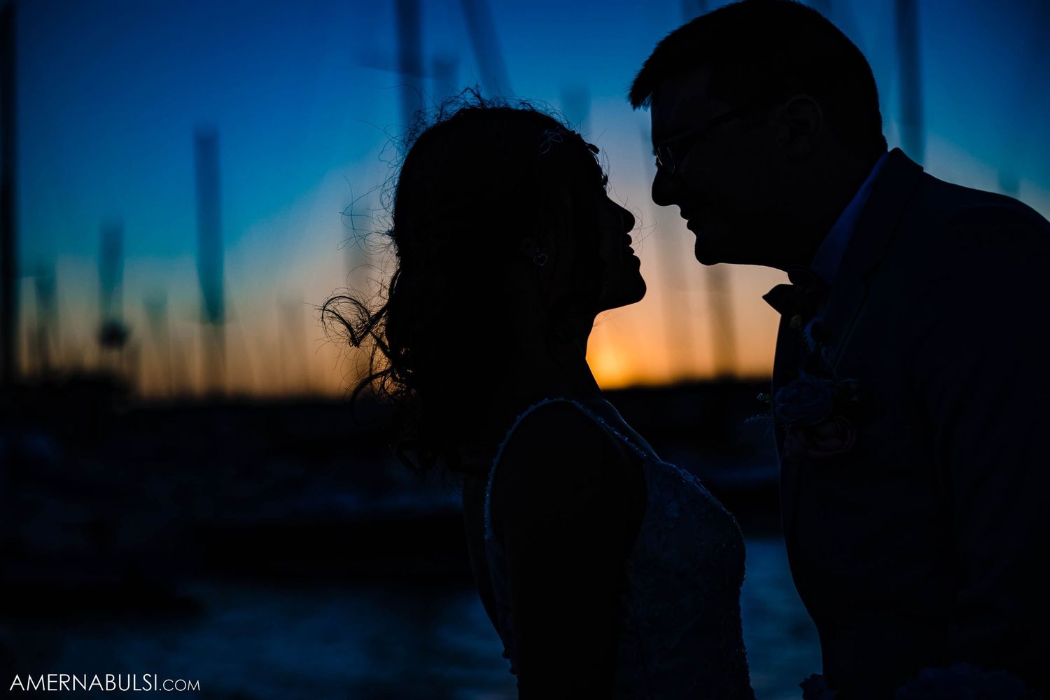 Romantic silhouette of a couple against a vibrant sunset sky.