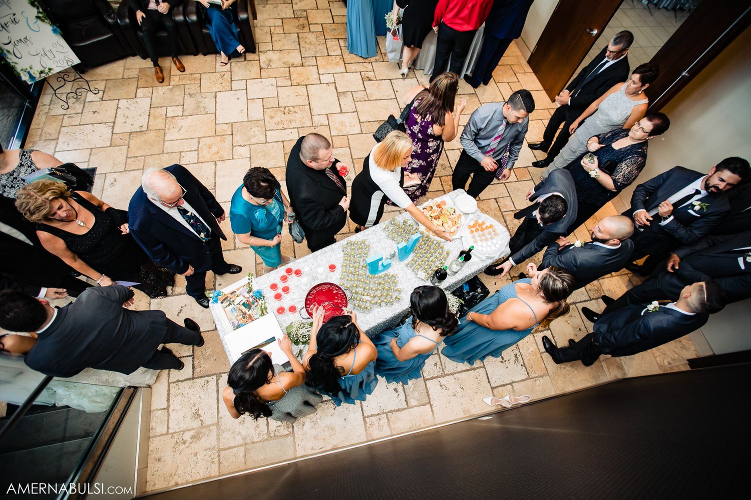 Overhead view of wedding guests seated in curved rows at an indoor venue.