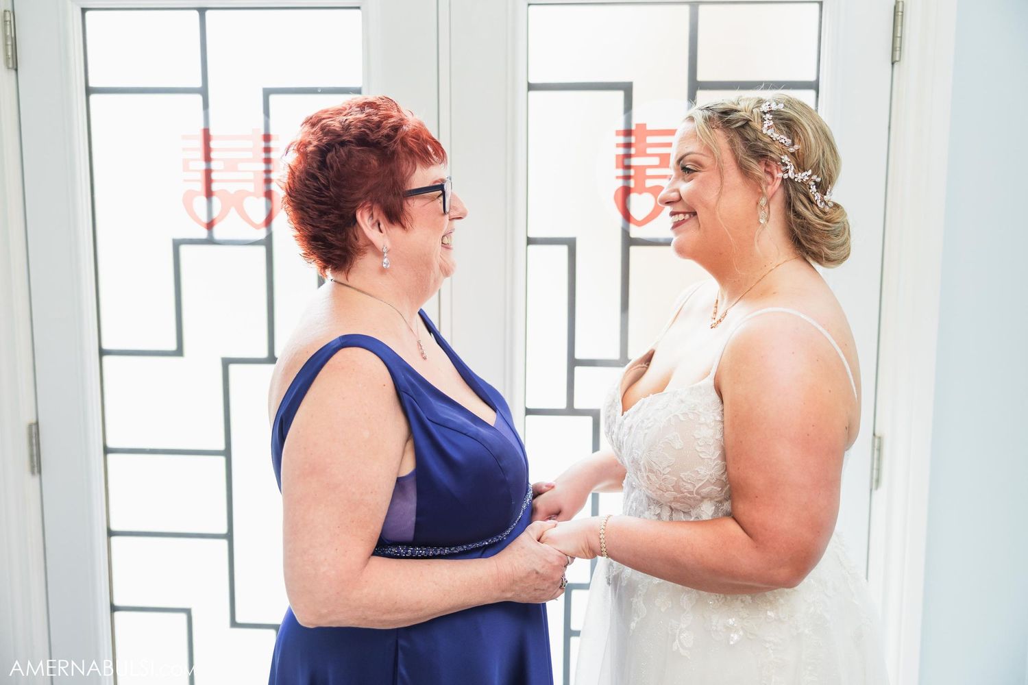 Wedding preparation moment in room with geometric window design.