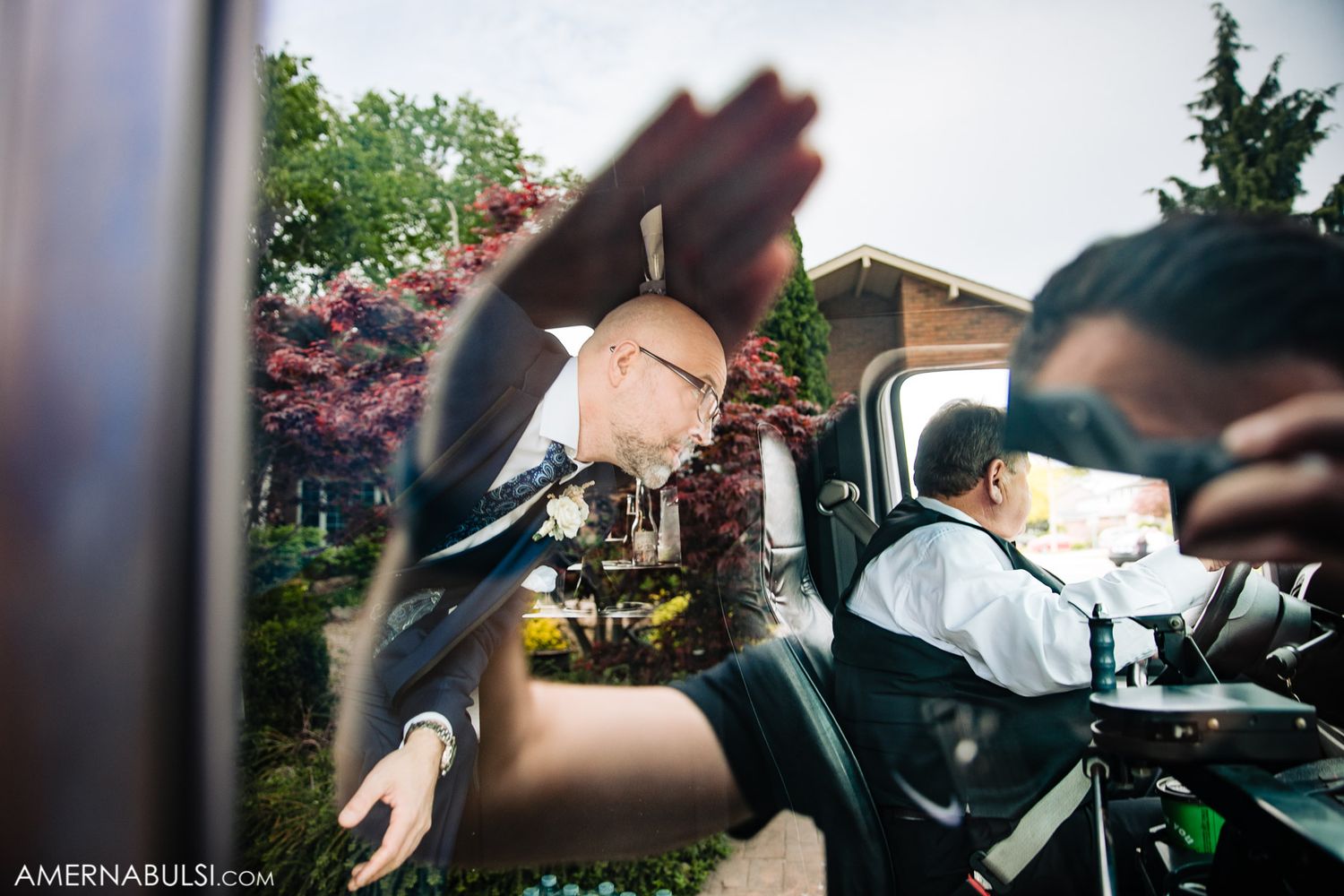 Artistic motion blur photo of passengers in a car on a sunny spring day with blooming trees in background.