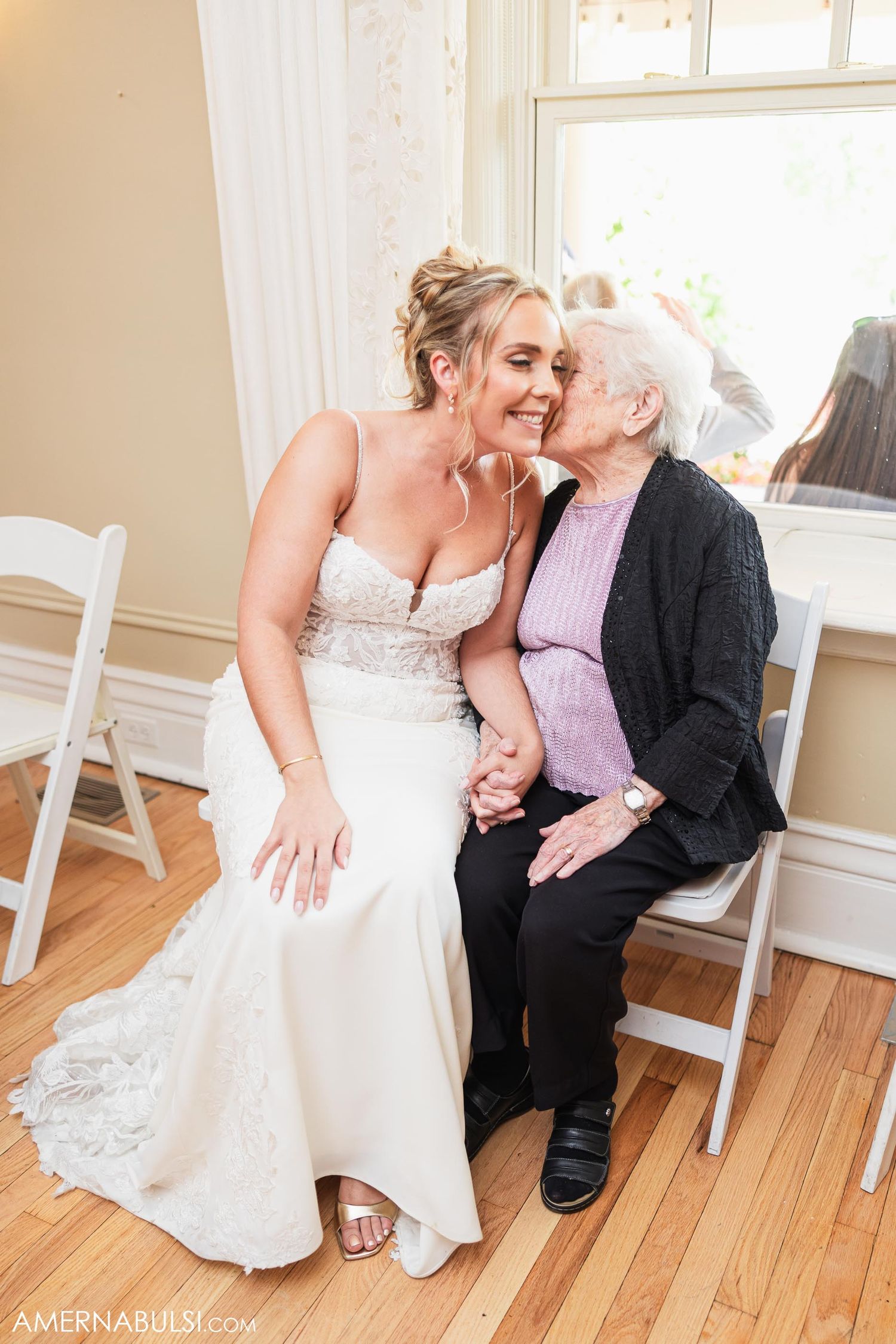 A touching candid moment shared between generations during a wedding celebration.
