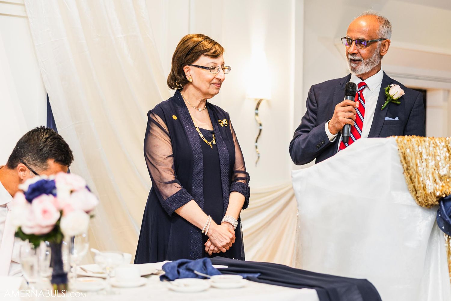 Speakers addressing guests during wedding reception speeches.