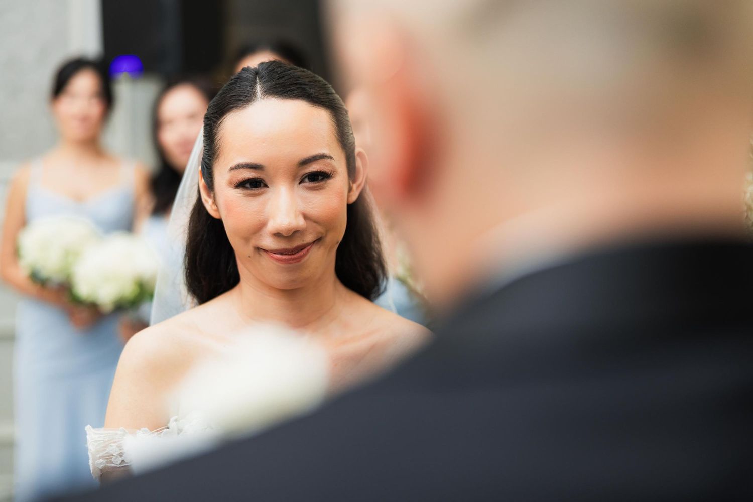Intimate wedding ceremony moment with soft natural lighting.