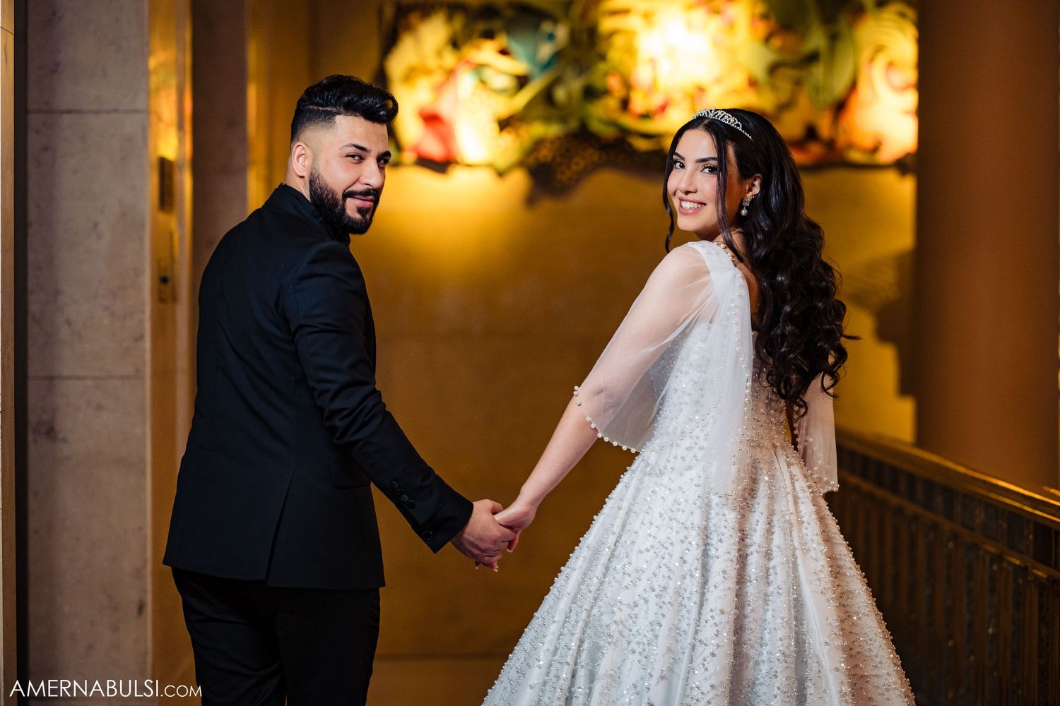 Romantic evening scene in an ornate hallway with warm lighting and architectural details.