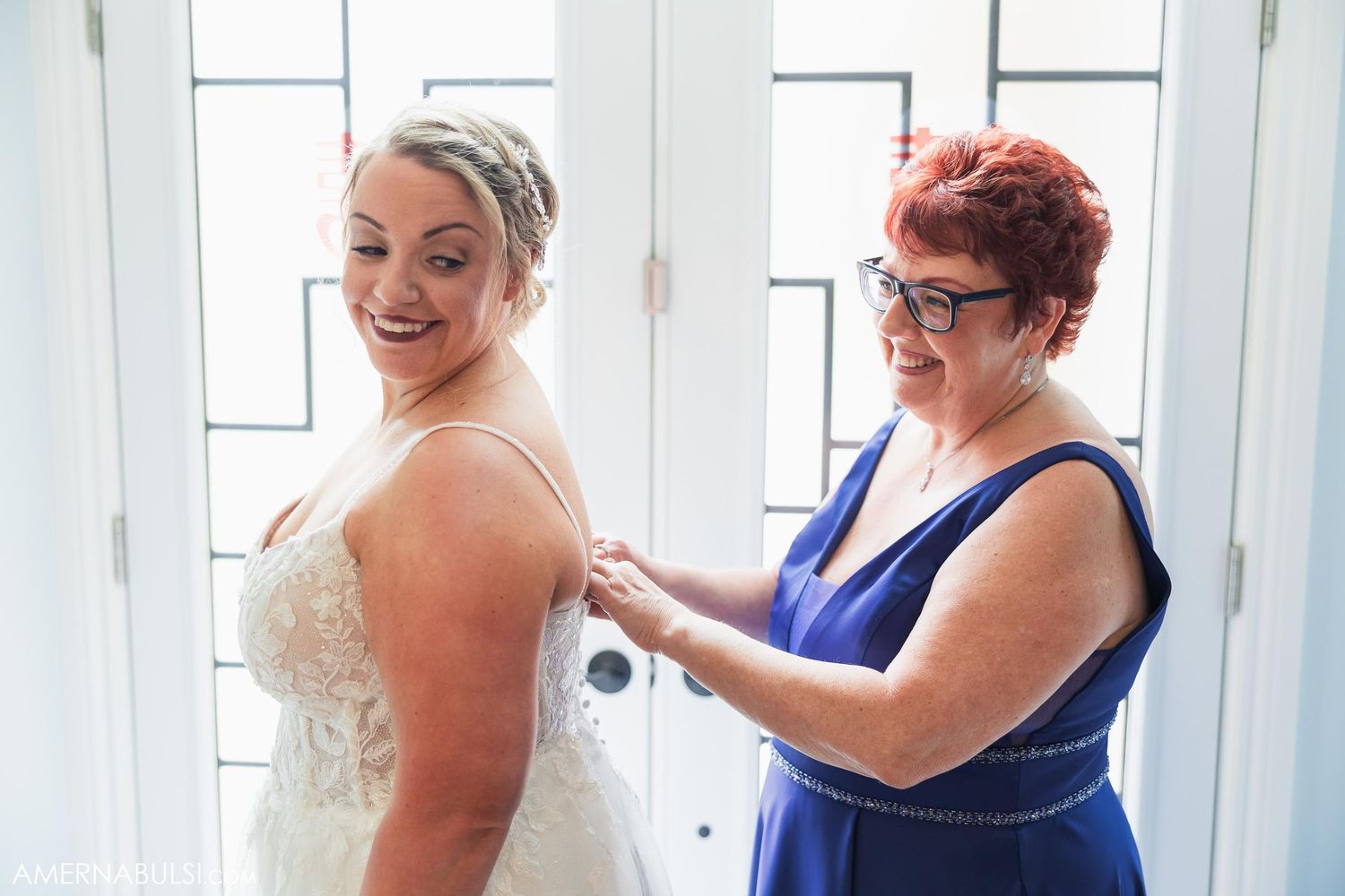 Final dress adjustments being made during wedding preparation.