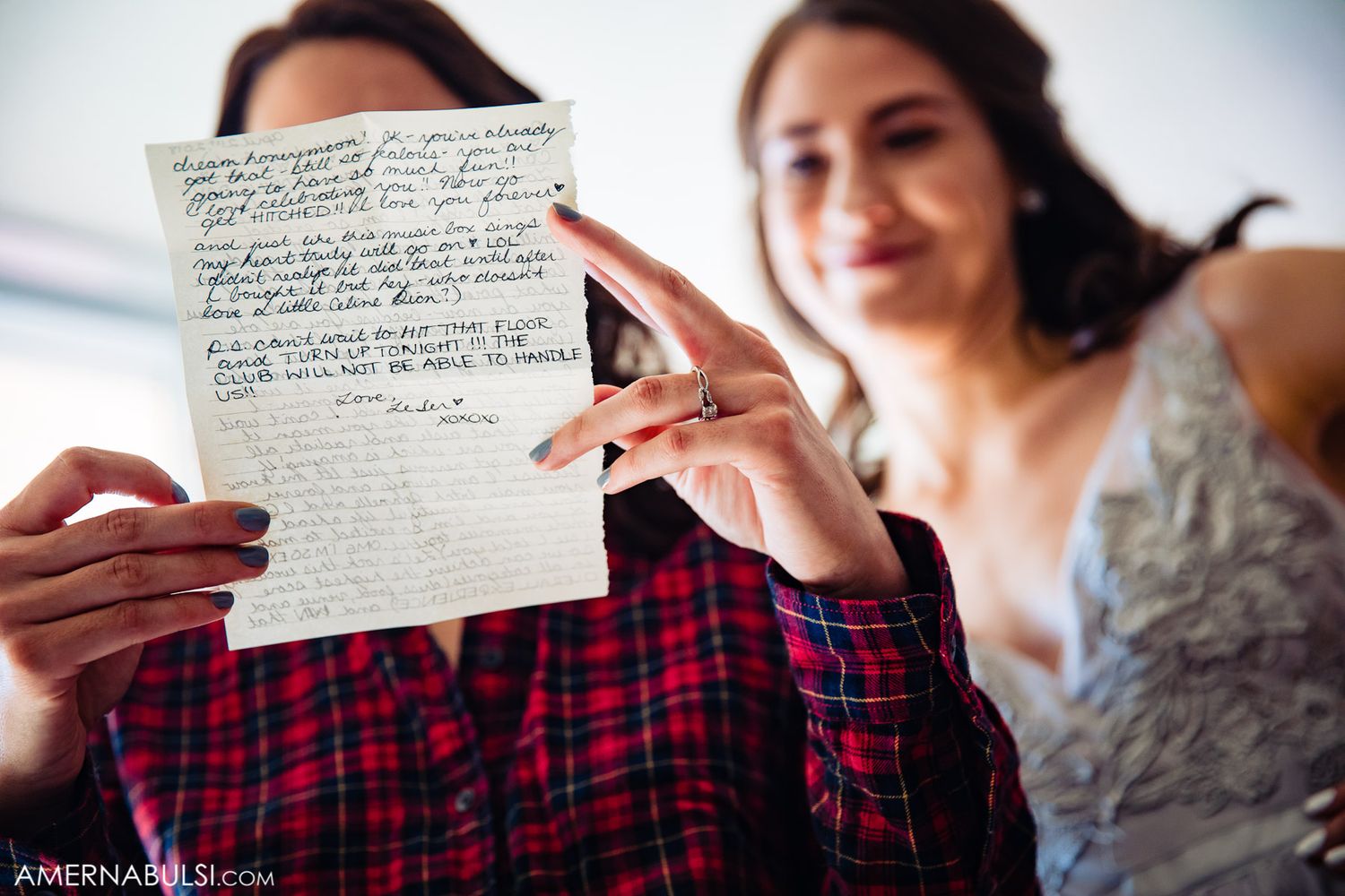 Two people reviewing handwritten wedding vows together before the ceremony.