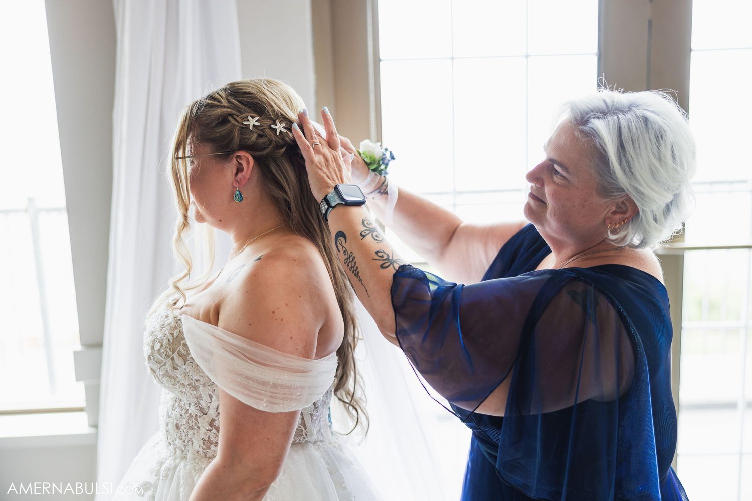Getting ready scene in bright indoor venue shows final wedding day preparations.