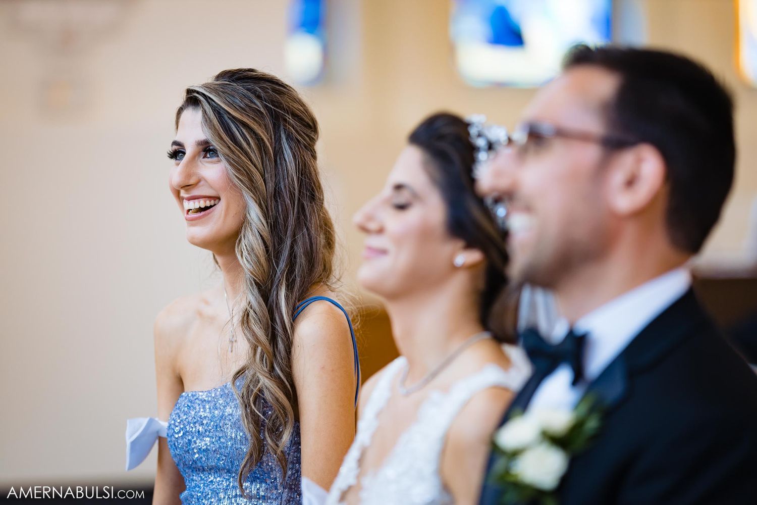 Wedding party members sharing happy moment during celebration.