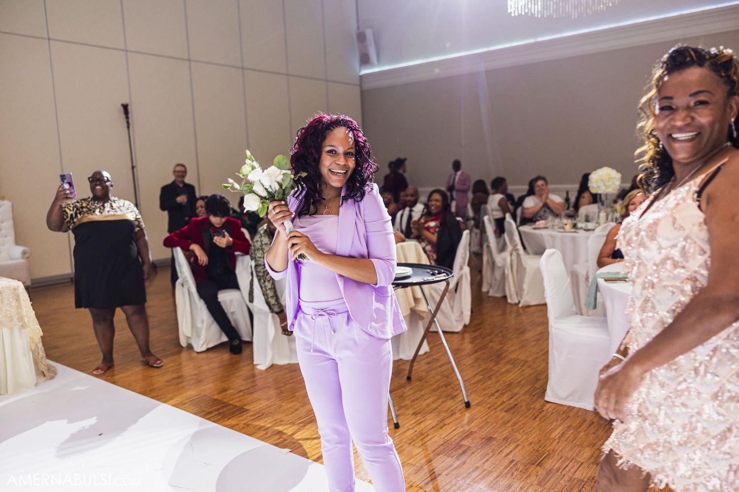 Wedding guests enjoying festivities on the dance floor of an elegant reception venue.
