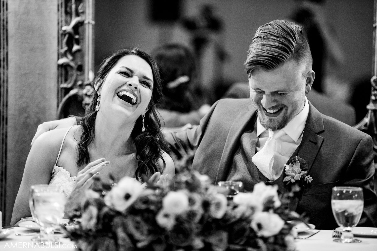 Black and white candid shots of wedding guests laughing and celebrating at a reception.