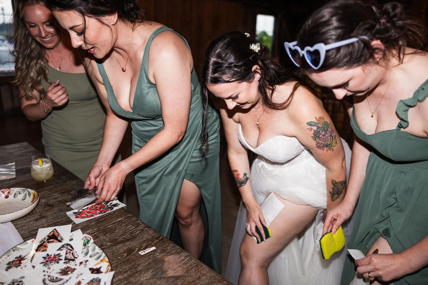 Wedding party gathered around a dessert table at reception.