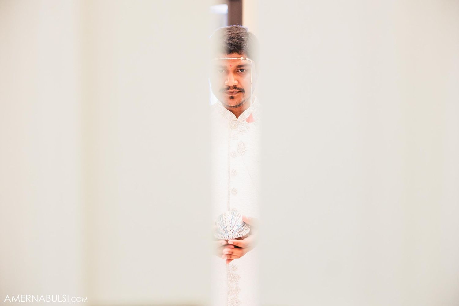 Artistic wedding photo taken through decorative architecture detail.