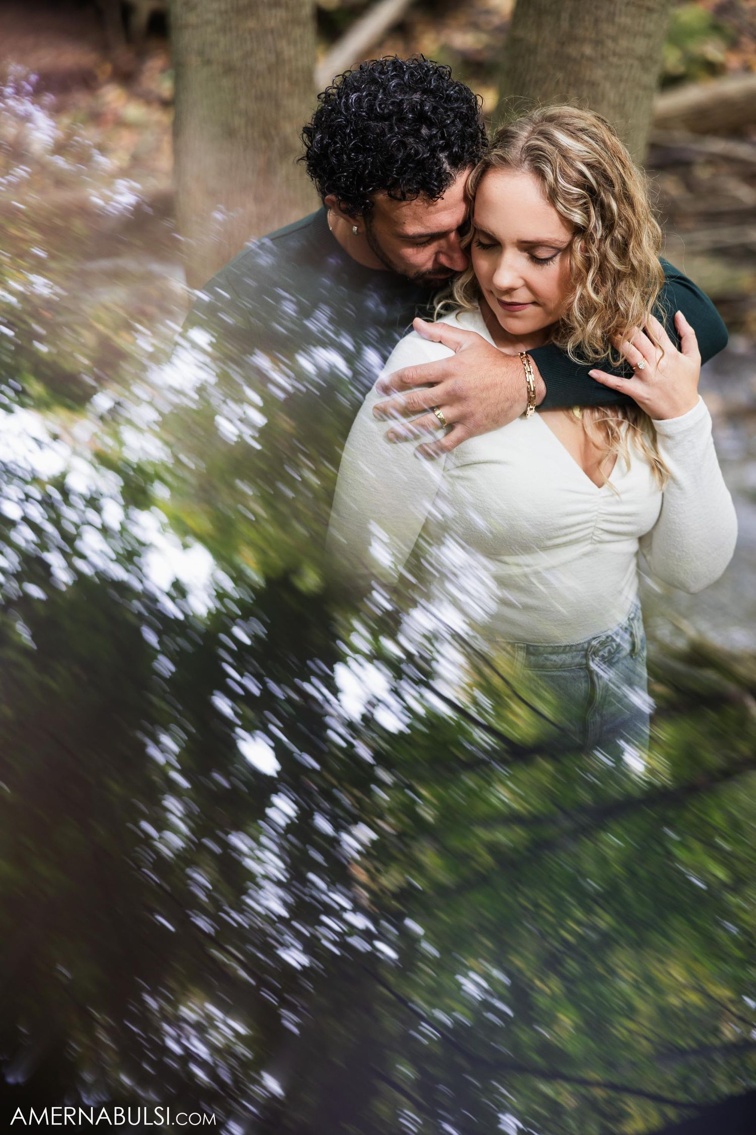 A romantic moment captured by a stream with soft water reflections in the background.