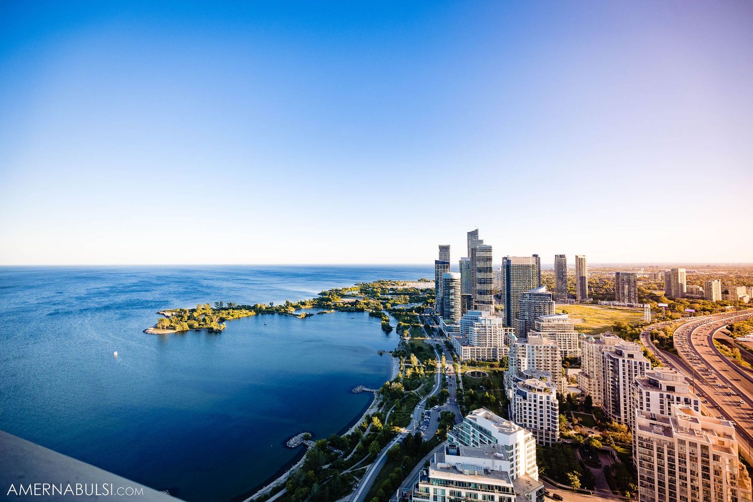 Aerial view of Toronto city skyline and waterfront during sunset.