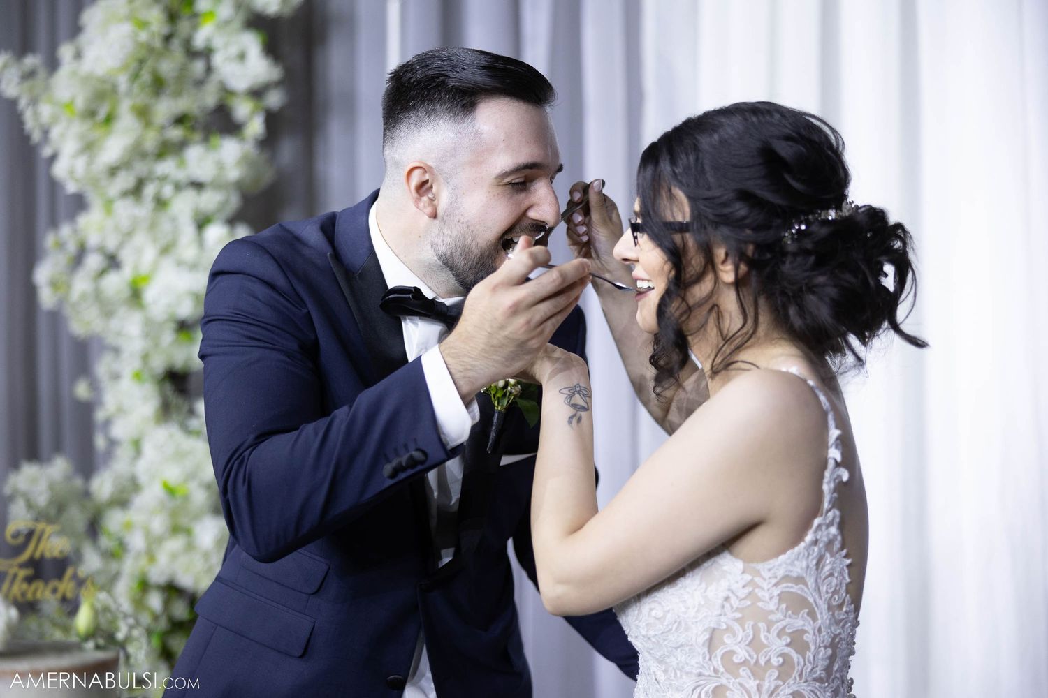 Playful wedding couple sharing a sweet moment during their reception festivities.