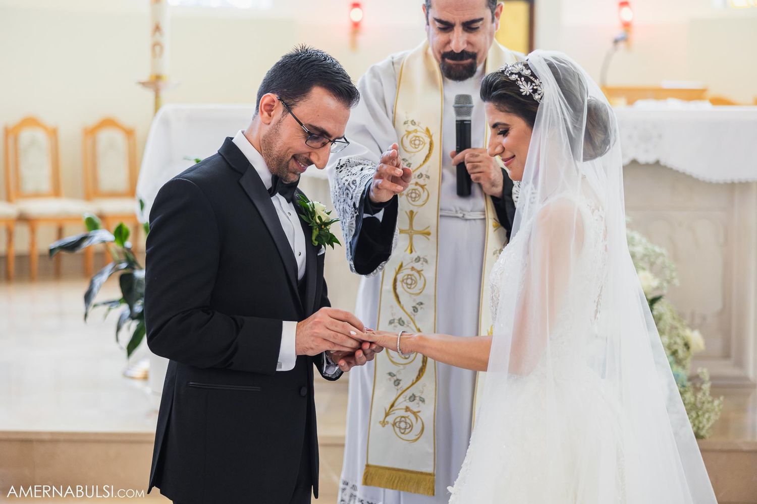 Wedding ceremony in progress with couple exchanging rings at church altar.