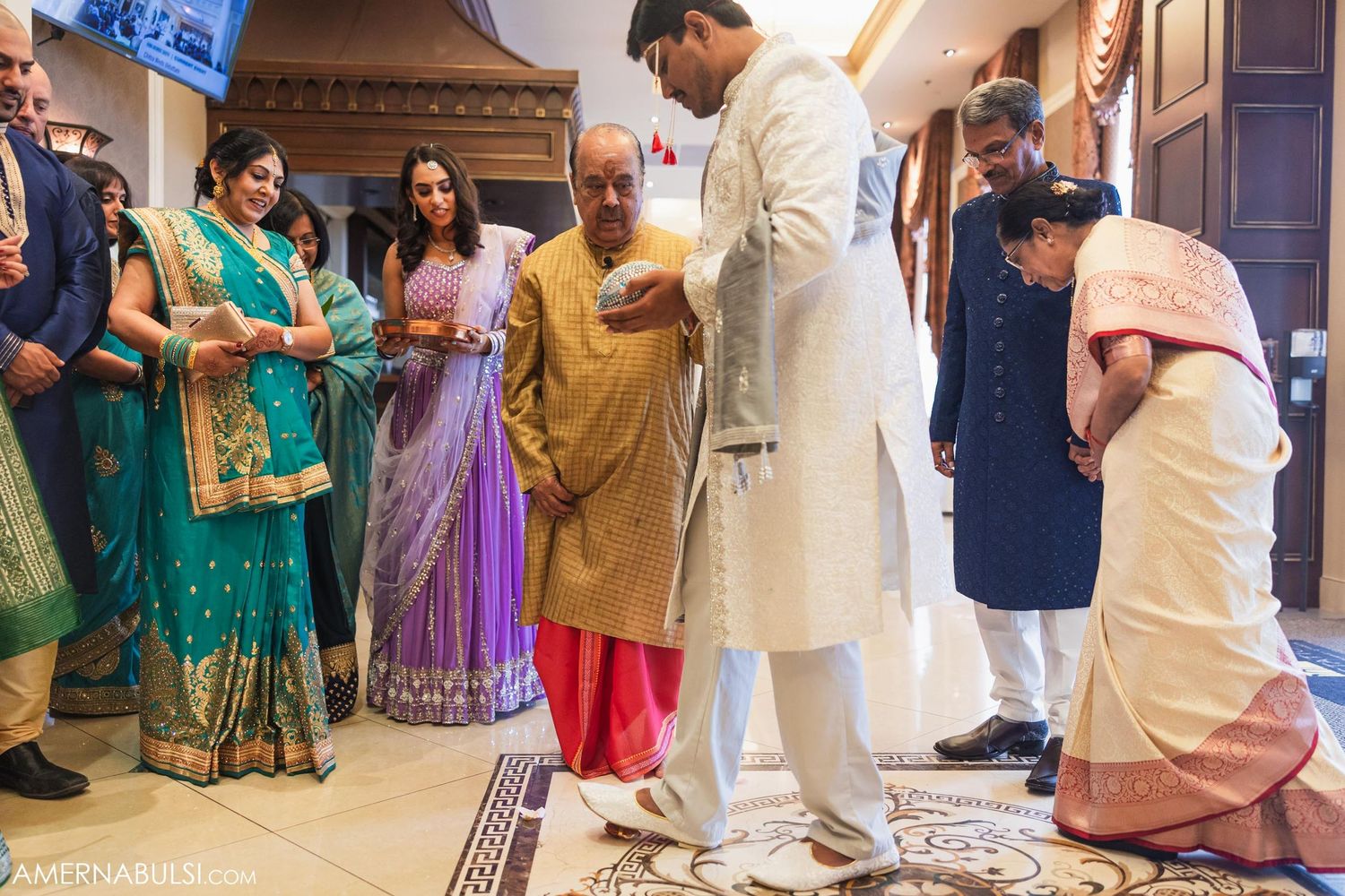Traditional Indian ceremony with guests in colorful saris gathered for a ritual.