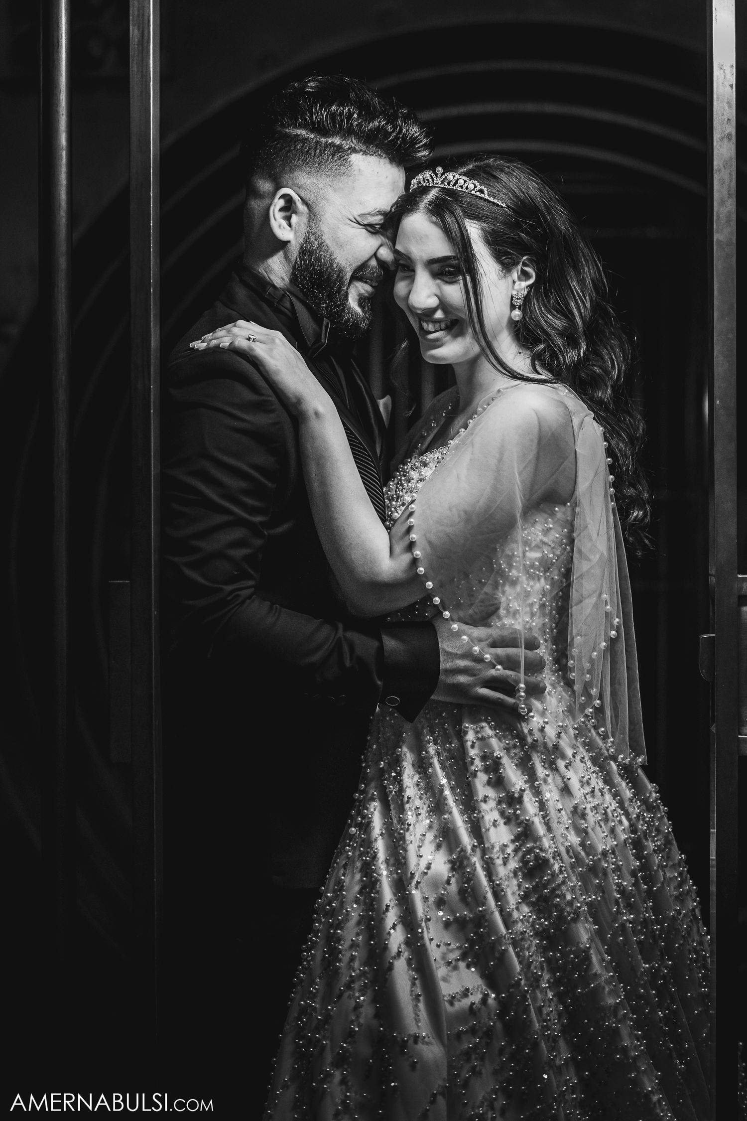 Romantic black and white wedding portraits showing intimate moments between newlyweds in dramatic lighting.
