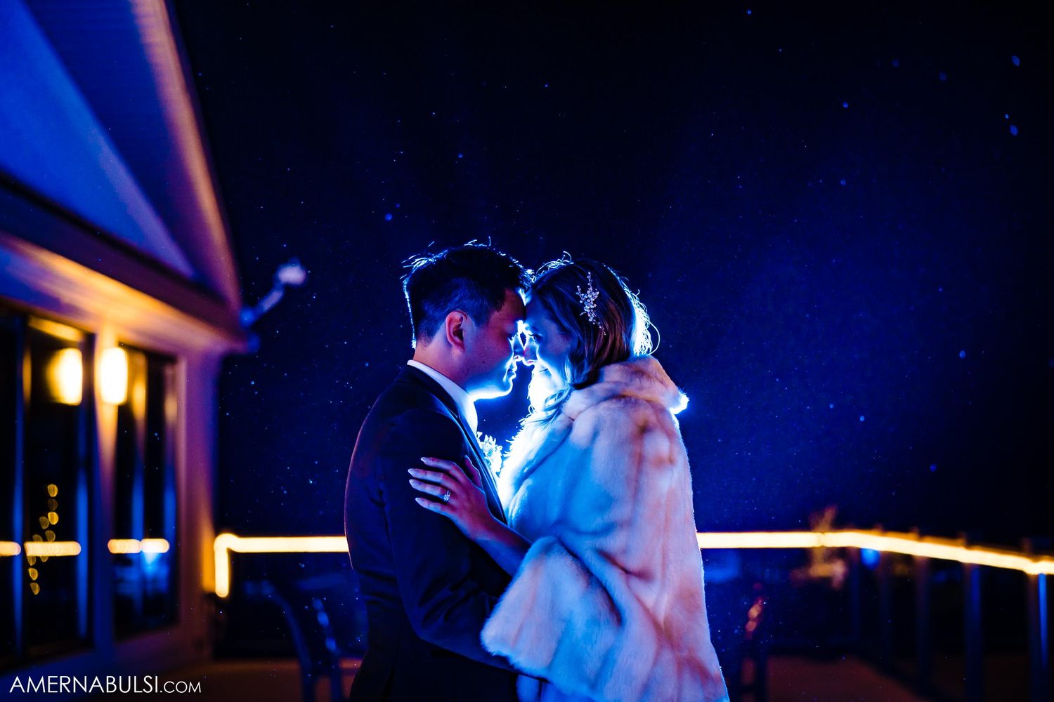 A romantic nighttime dance scene with soft blue lighting on an outdoor patio.
