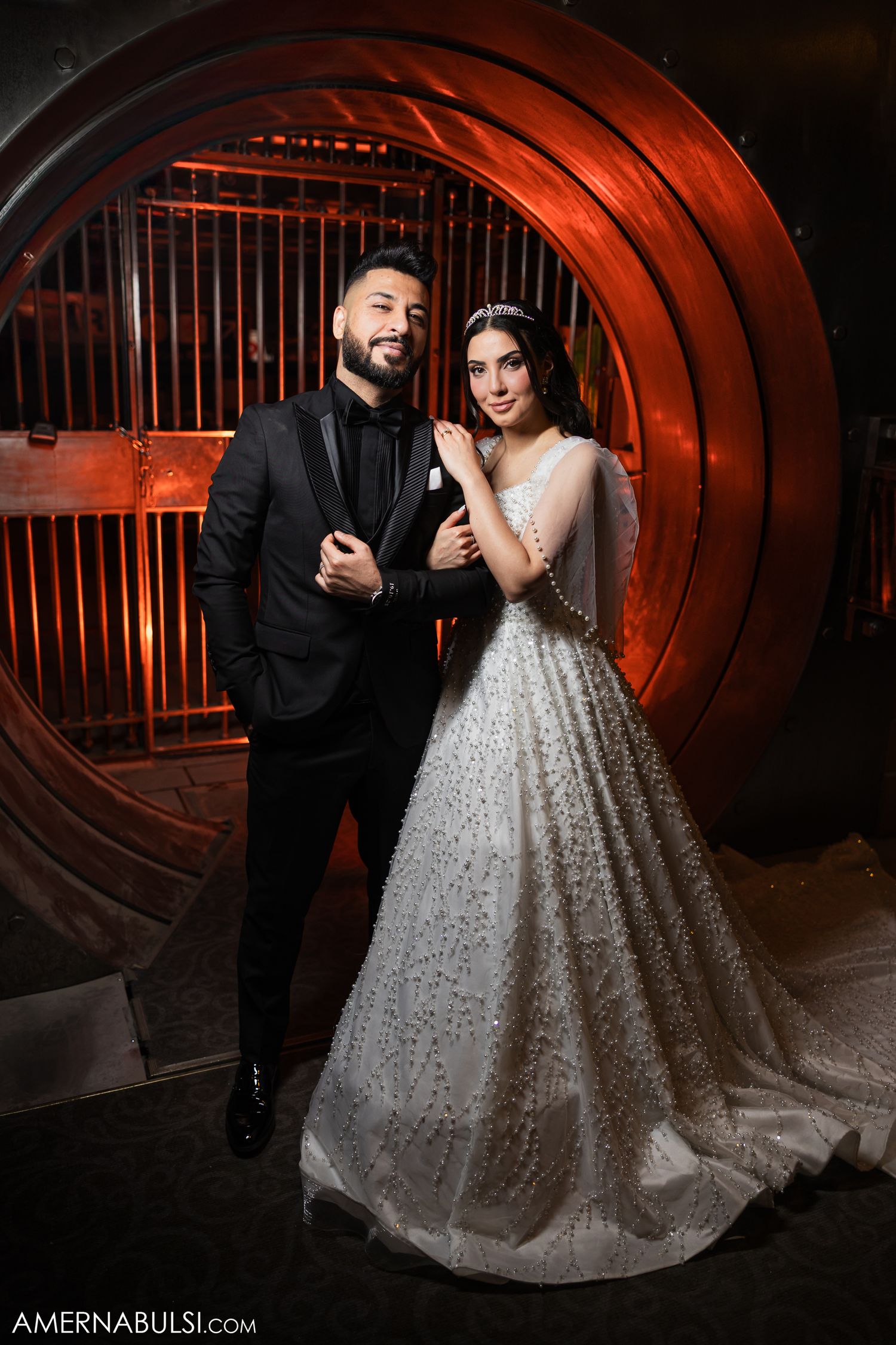 Dramatic wedding photography in a tunnel with moody red lighting and industrial architecture.
