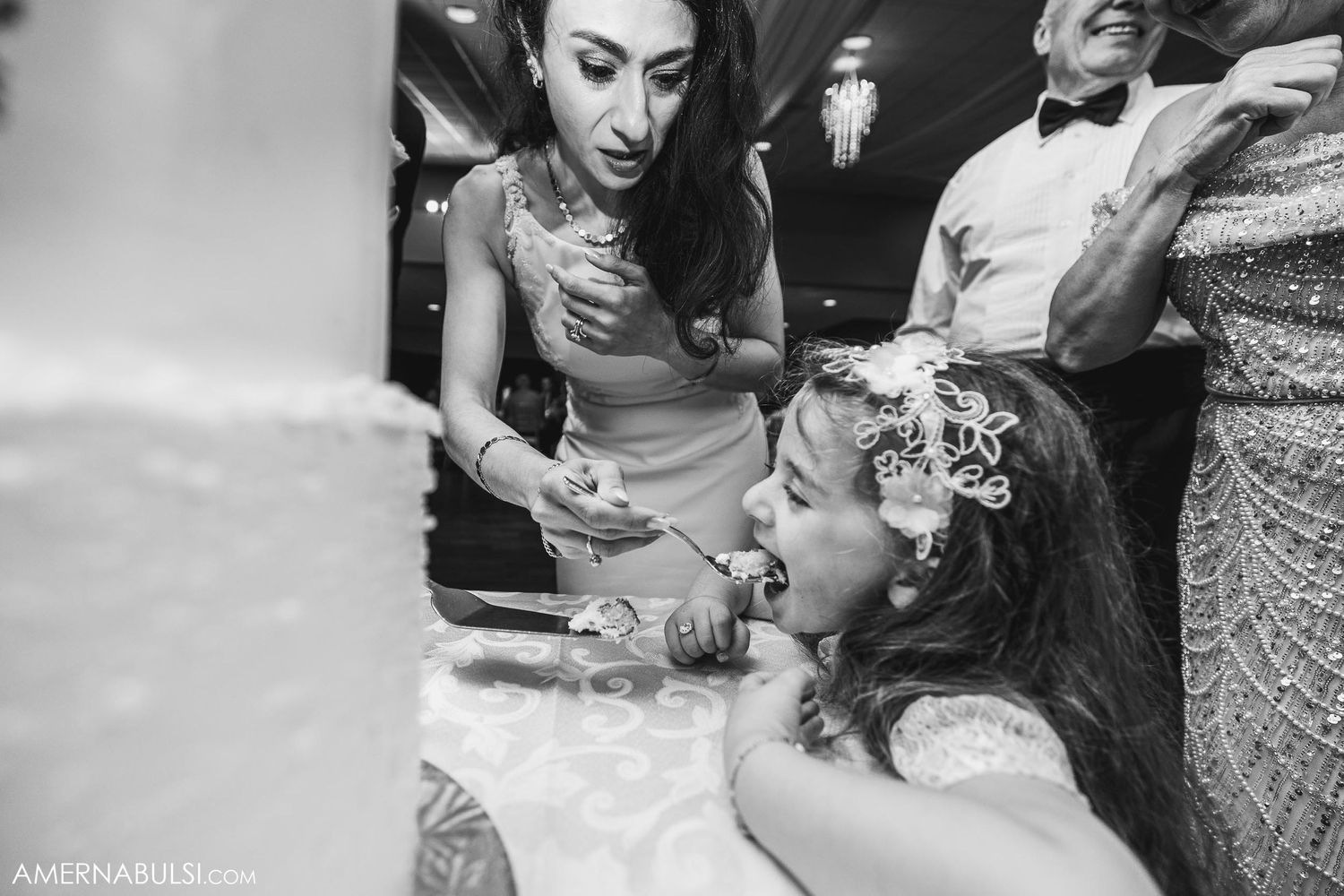 Candid black and white moment captured during wedding celebrations.