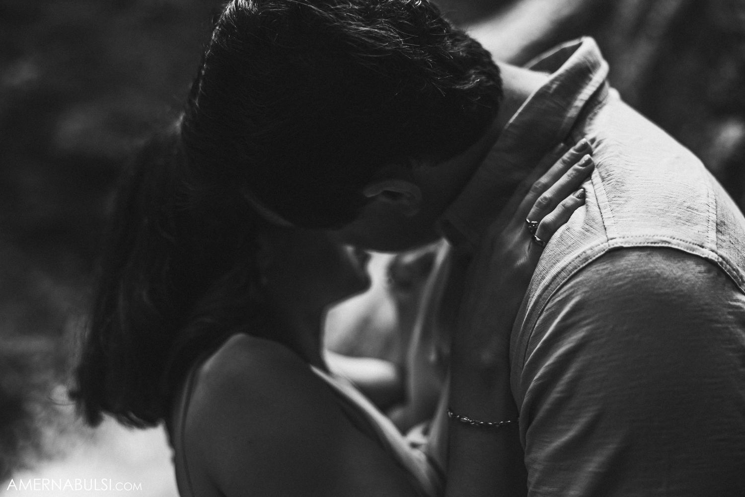 Intimate black and white close-up of couple's tender embrace.