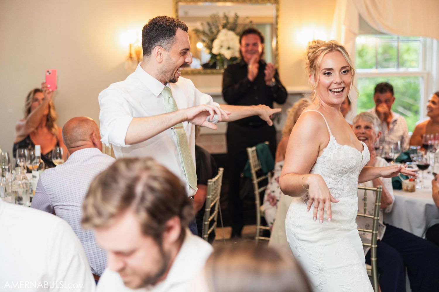 Reception celebration with guests celebrating at decorated wedding tables.