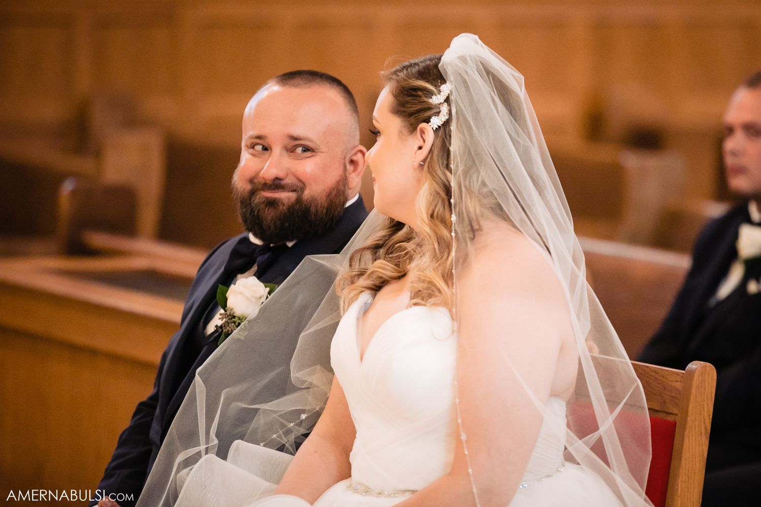 Wedding ceremony candid moments captured in warm lighting inside a traditional church setting.