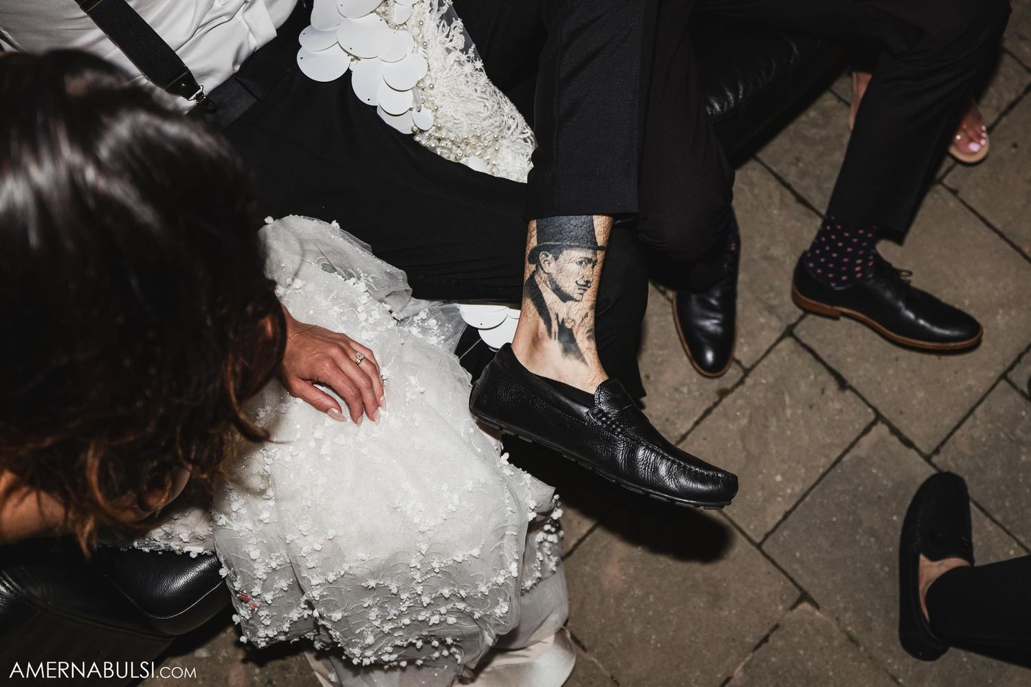Detail shot of someone taking photo on phone next to flowing white dress fabric.
