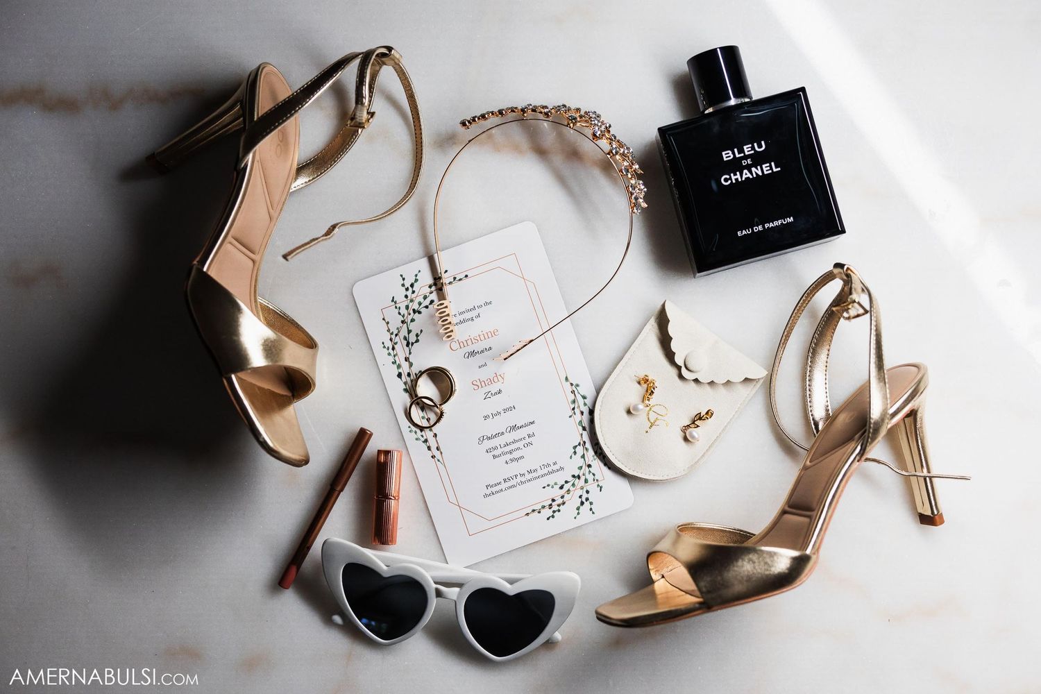 Wedding accessories flatlay with gold shoes, perfume bottle, invitation and sunglasses.
