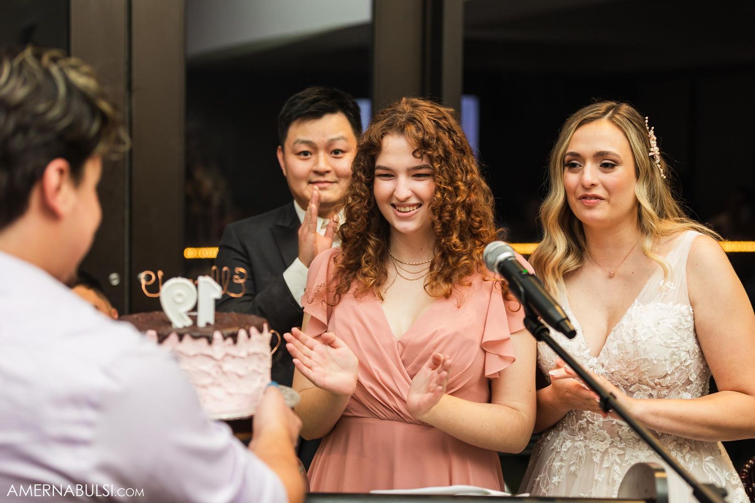 Reception speeches being given at an elegant wedding celebration with decorative lighting.