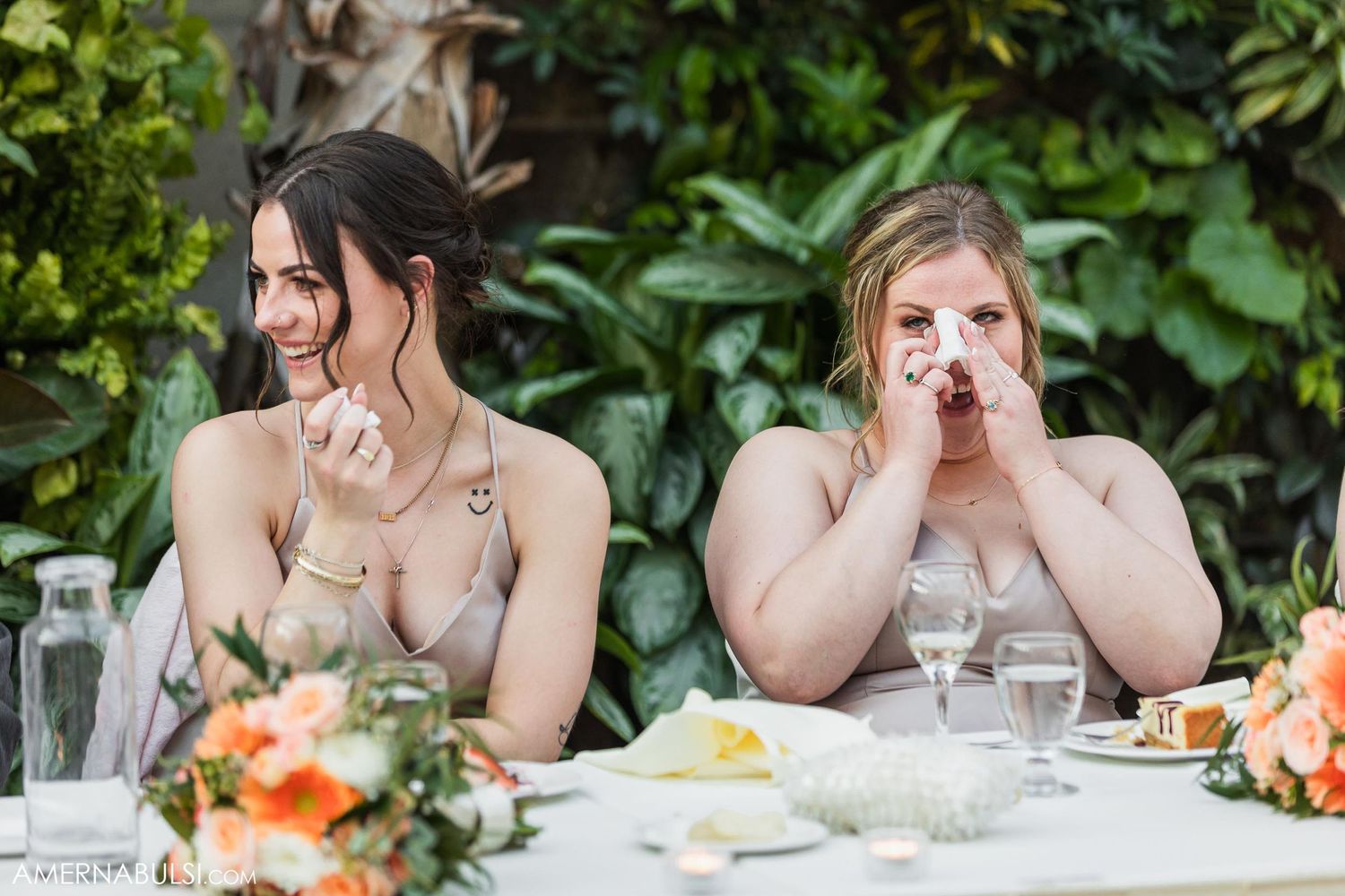 Bridesmaids share an emotional moment during the wedding reception dinner.