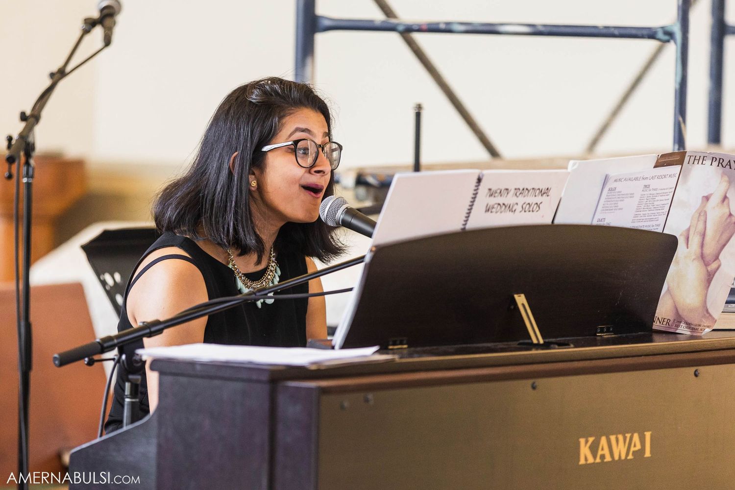 A pianist performs at a Kawai piano during a wedding ceremony.
