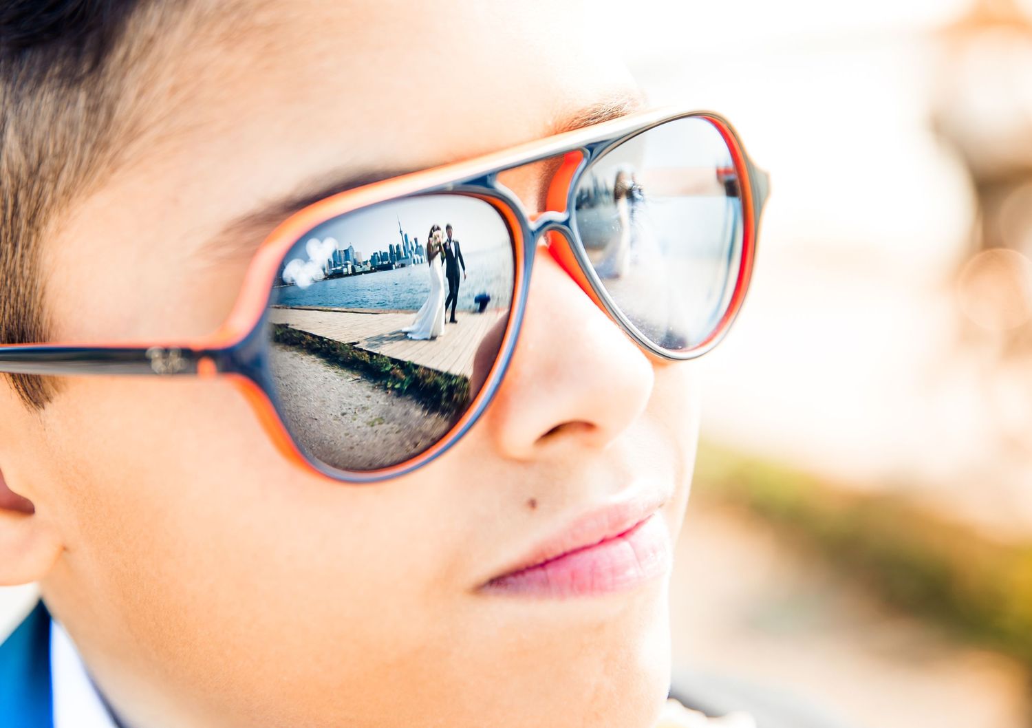 Creative wedding photography captured through reflections in sunglasses.
