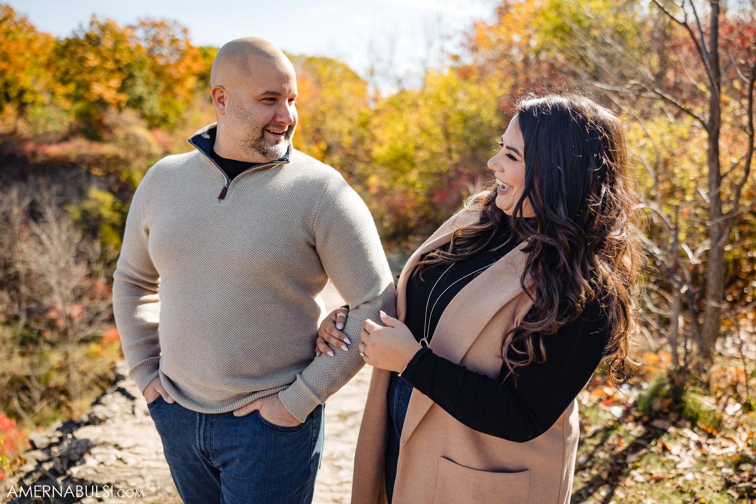 Casual conversation captured during autumn engagement photoshoot with natural expressions.