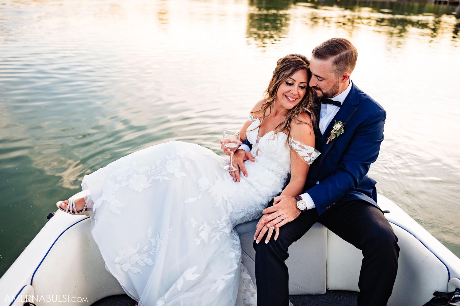 A romantic moment captured of a couple in formal attire on a boat.