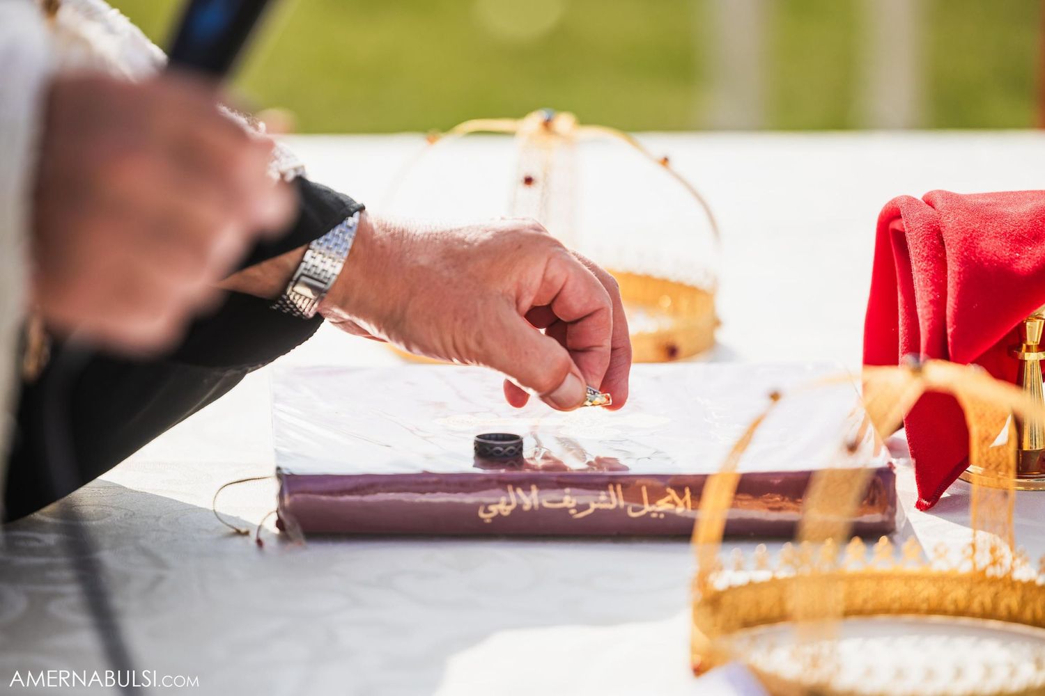 Close-up of hands signing documents on a table with bread displayed.