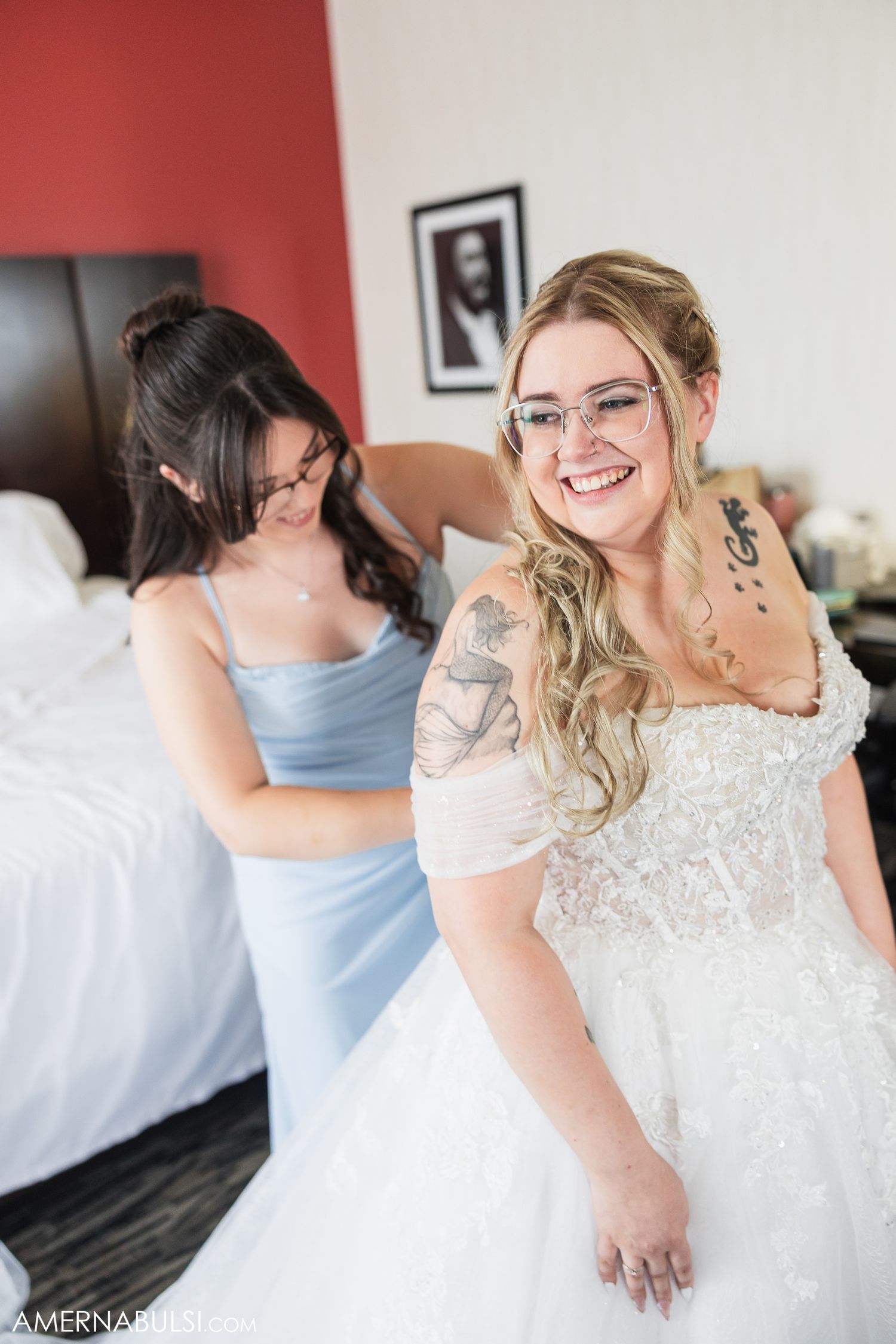 Bridal party getting ready in a room with white and red walls.