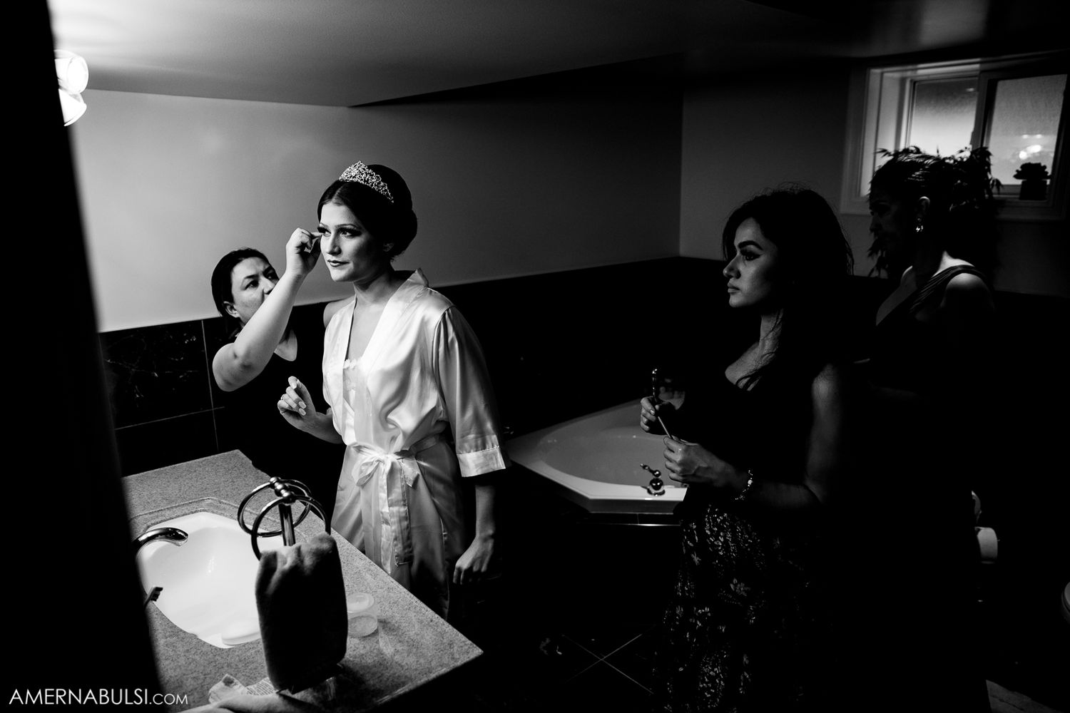 Black and white candid moments captured during wedding preparation.