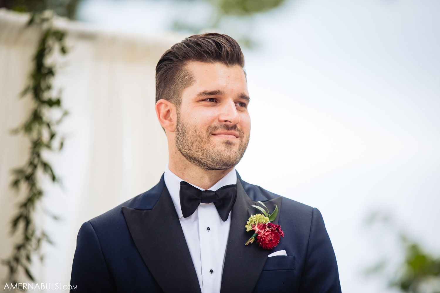 Elegant wedding party in formal attire standing together outdoors.