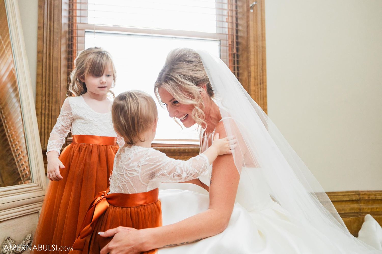 Sweet moment of tenderness captured near a window in soft natural light.