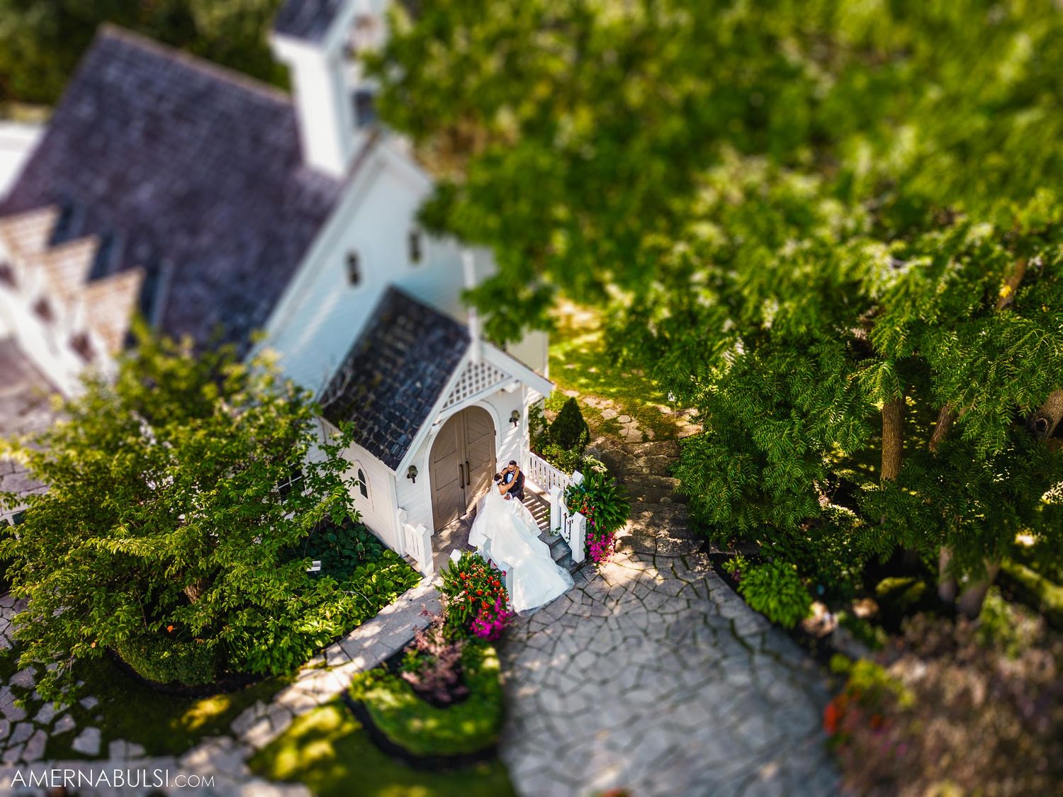 A tilt-shift photo creates a miniature effect of a chapel wedding scene.