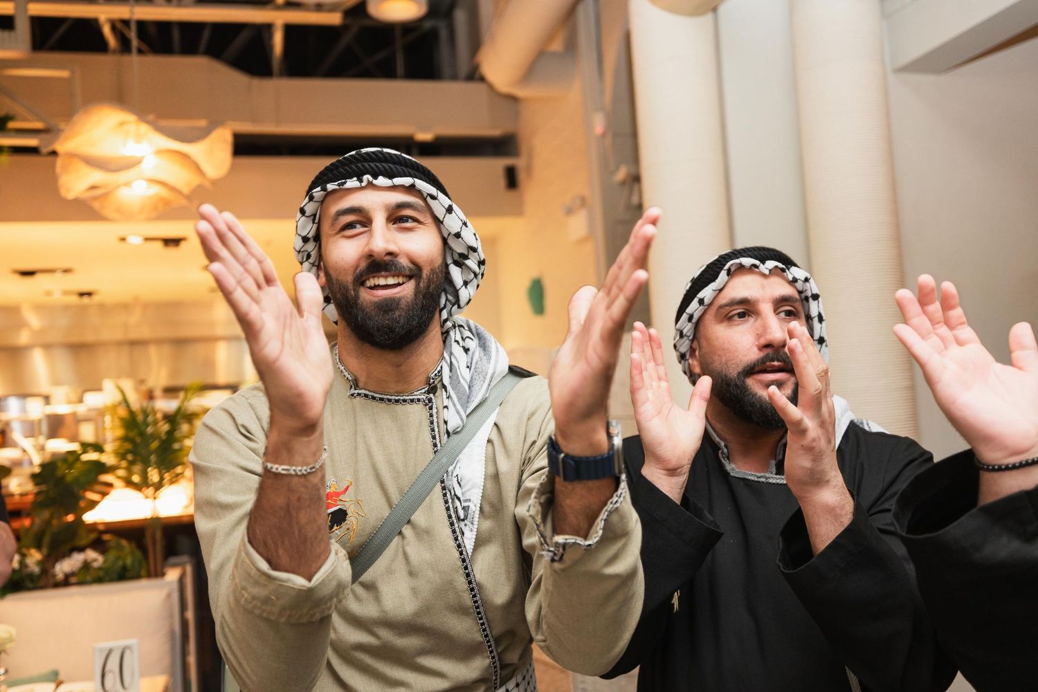 Two guests cheering enthusiastically during a wedding celebration.
