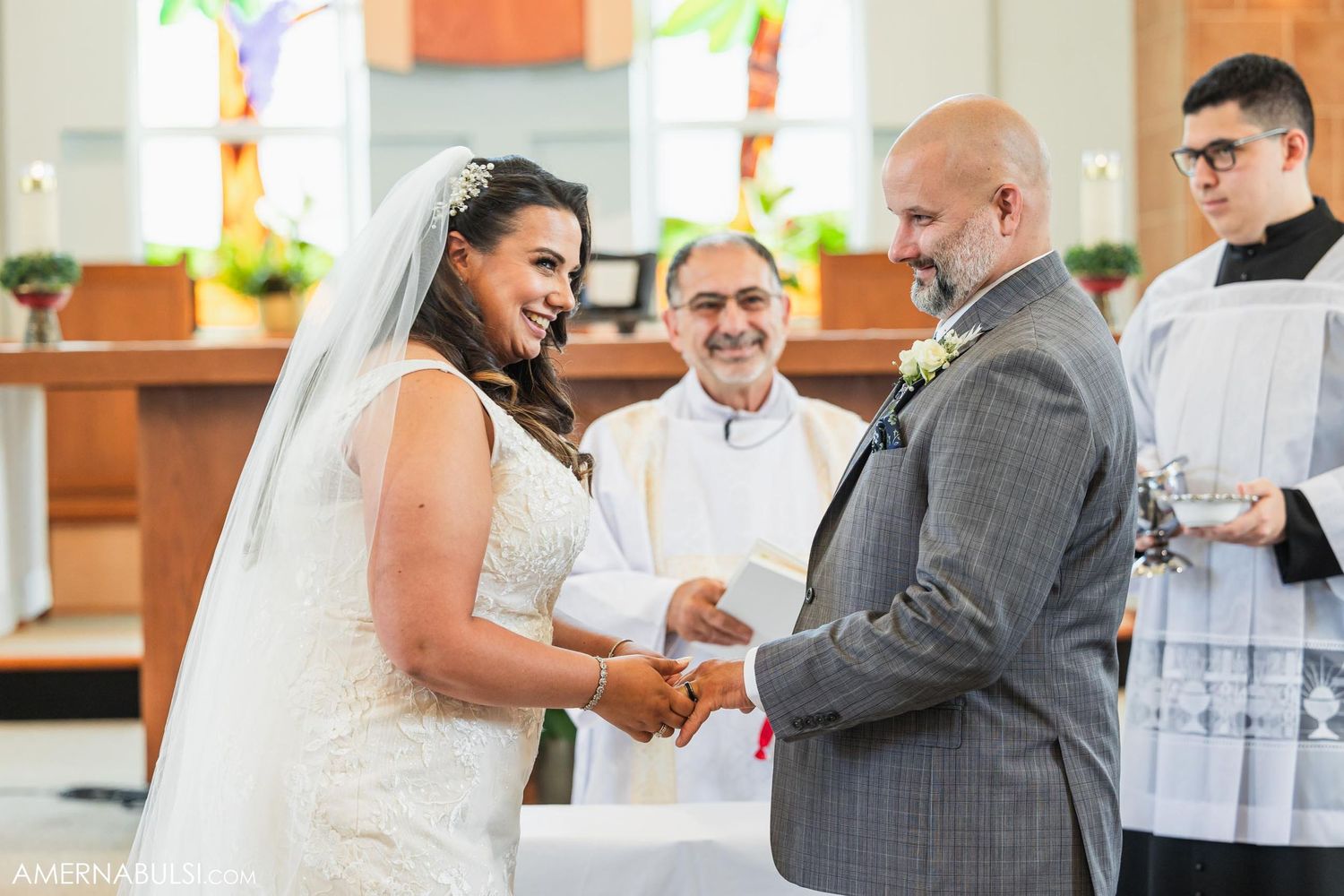 Wedding ceremony at altar with officiant and traditional church decor.