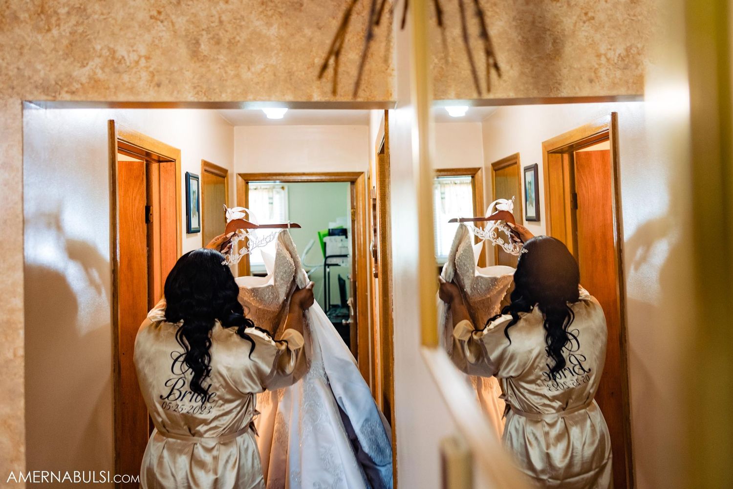 Mirror reflection shows wedding preparation moments as attendants help with final dress adjustments.