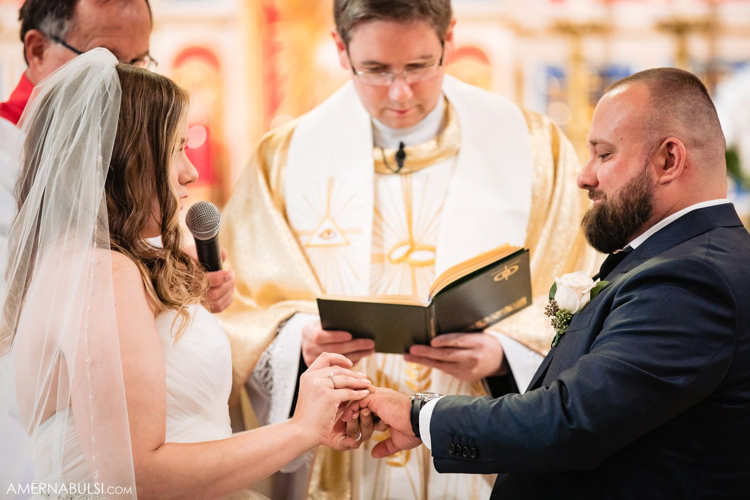 Intimate wedding ceremony moments showing exchange of rings in an elegant church interior.