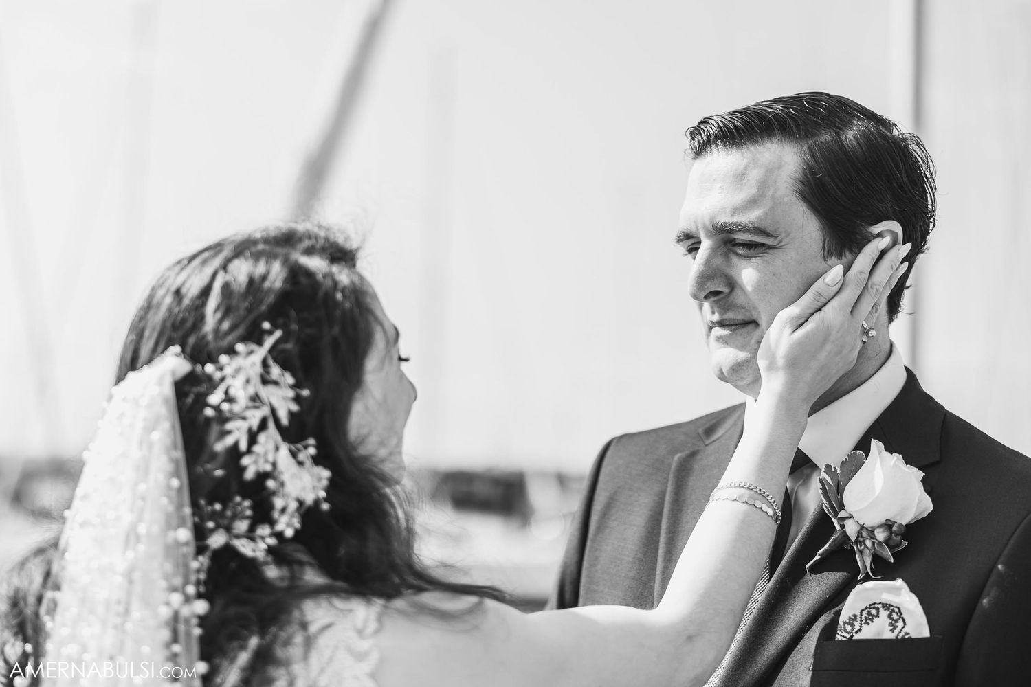 An intimate black and white wedding moment captured between a couple during their ceremony.