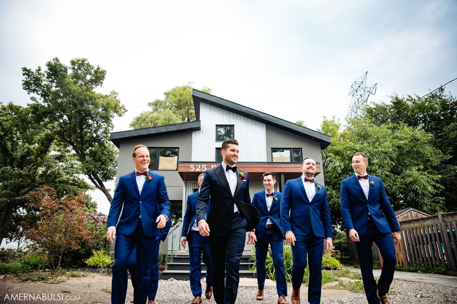 Groomsmen in bright blue suits walking together outdoors on wedding day.